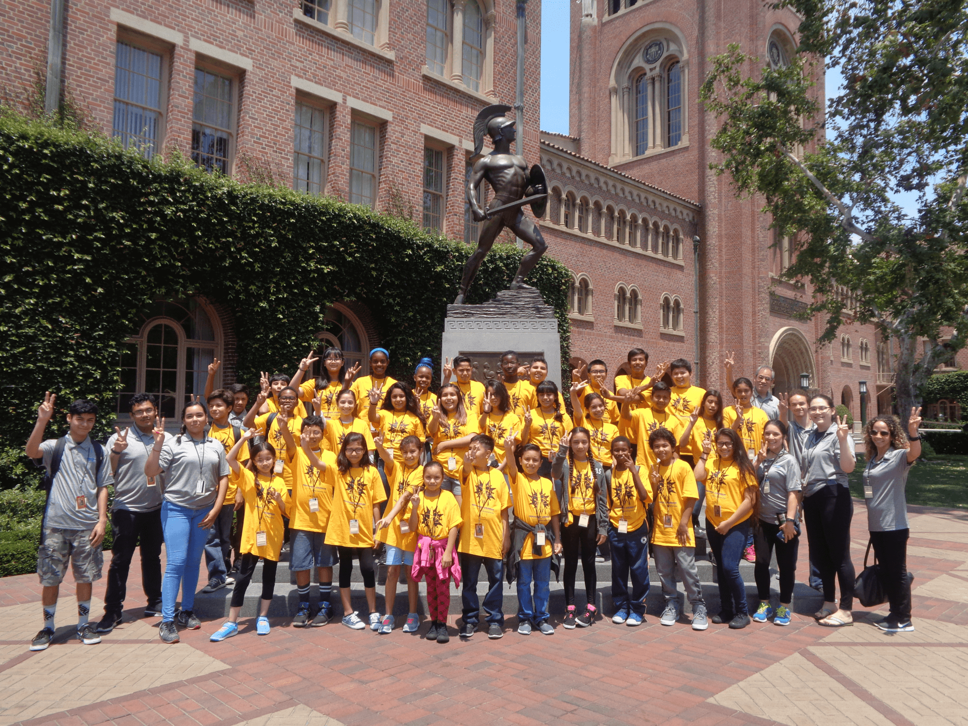 Camp participants, camp counselors, and staff in front of Tommy Trojan.
